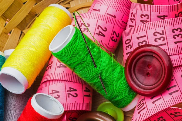 Colorful threads with a needle and a meter — Stock Photo, Image