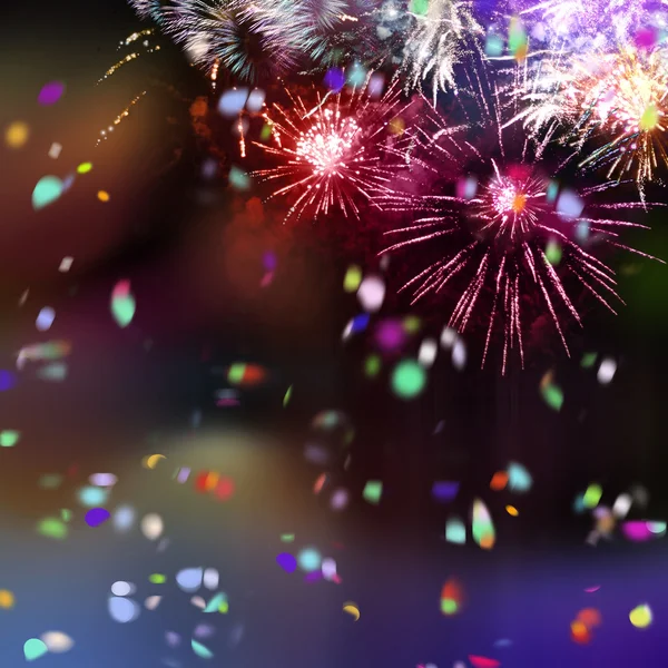 Bright sparkling multicolor fireworks and confetti — Stock Photo, Image