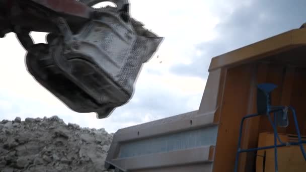 Excavator loads a truck rock in the quarry — Stock Video