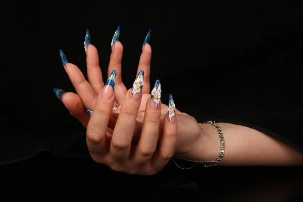 Pretty woman hand with perfect painted nails isolated on black background — Stock Photo, Image