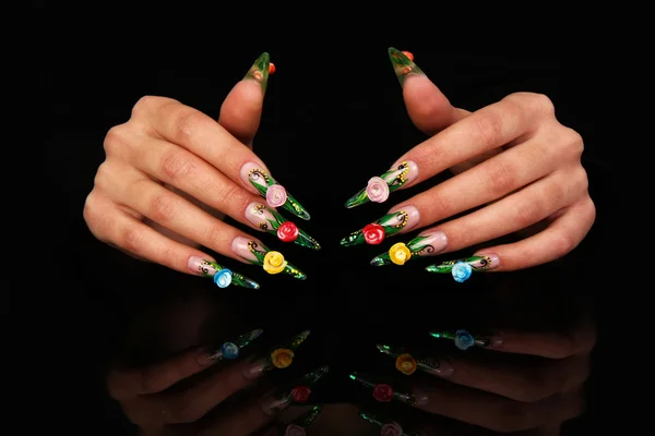 Pretty woman hand with perfect painted nails isolated on black background — Stock Photo, Image