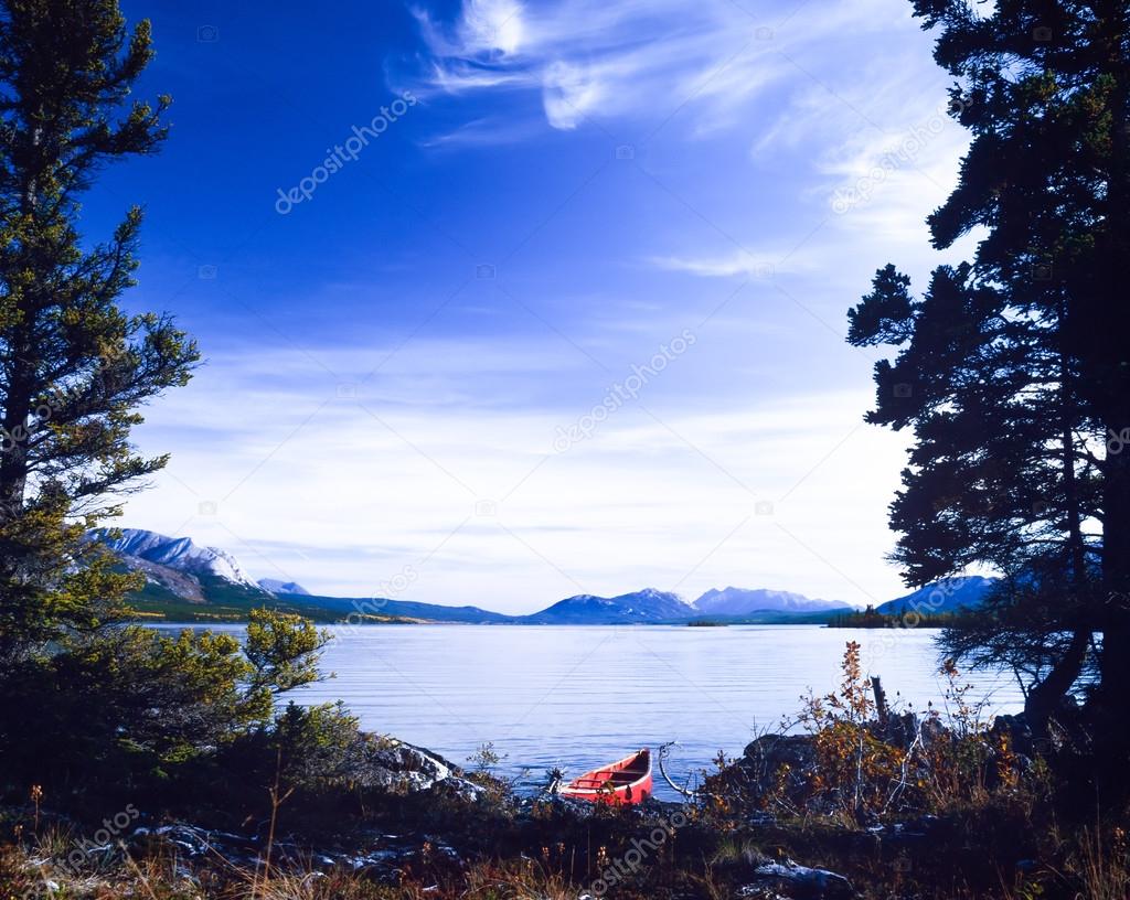 Tagish Lake Yukon Canada red canoe wilderness trip Stock Photo by