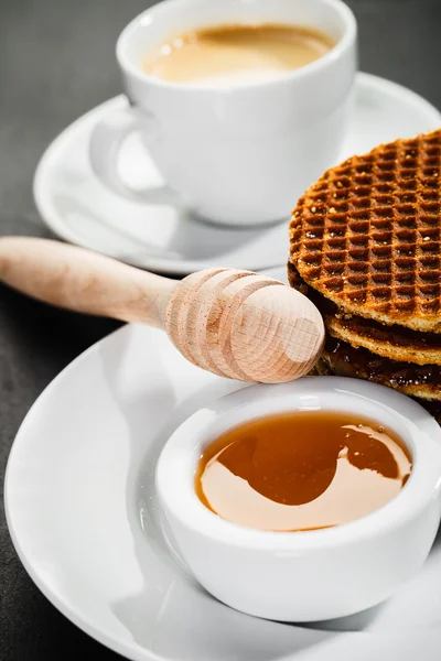 Honey waffles and coffee on ceramic background — Stock Photo, Image