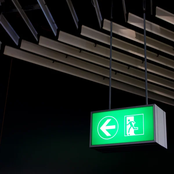 Emergency exit sign in modern offices inside an industrial plant — Stock Photo, Image