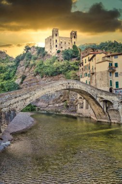 DOLCEACQUA, ITALY - CIRCA AĞUSTOS 2020: Taşlardan yapılmış antik Roma köprüsü ve kalesi ile Dolceacqua panoraması
