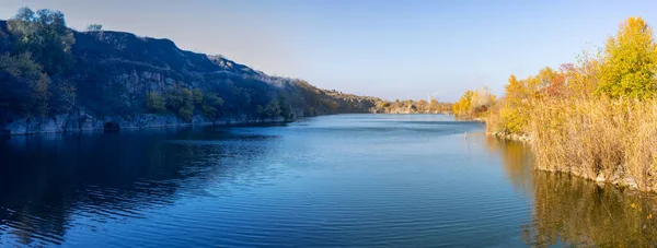 Panorama, beautiful autumn landscape. View of the lake in the quarry near the Kodak fortress, Ukraine on the blue sky background — Stock Photo, Image