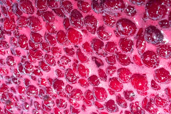 The texture is food-grade. Berries in the process of cooking cherry jam.