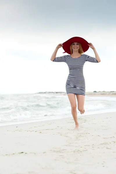 Beautiful Sexy Blonde Girl Striped Dress Red Hat Runs Beach — Stock Photo, Image