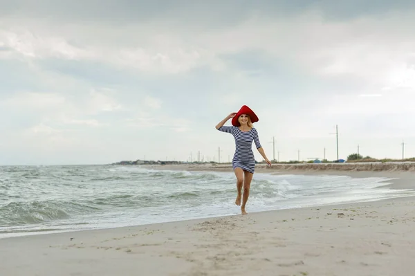 Beautiful Sexy Blonde Girl Striped Dress Red Hat Runs Beach — Stock Photo, Image