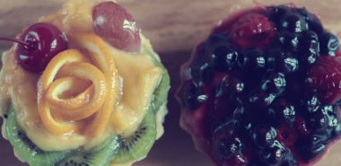 Dessert. Cake with fruit basket: currants, raspberries, kiwi, orange, cherry. Photos with a small depth of field