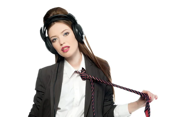 Flicka i kavaj och slips i hörlurar — Stockfoto
