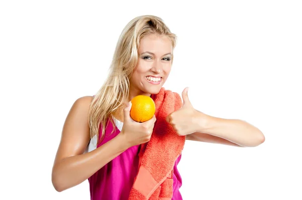 Woman in sporty clothes with orange — Stock Photo, Image
