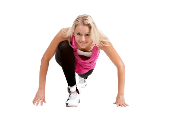 Ragazza bionda in vestiti sportivi che si estende — Foto Stock