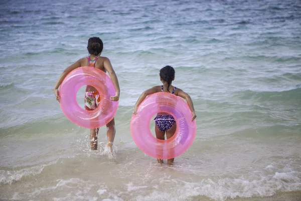 Sisters with float tubes — Stock Photo, Image