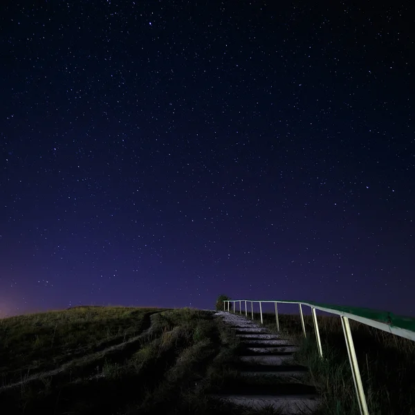 Stairway to hill on the background of night sky