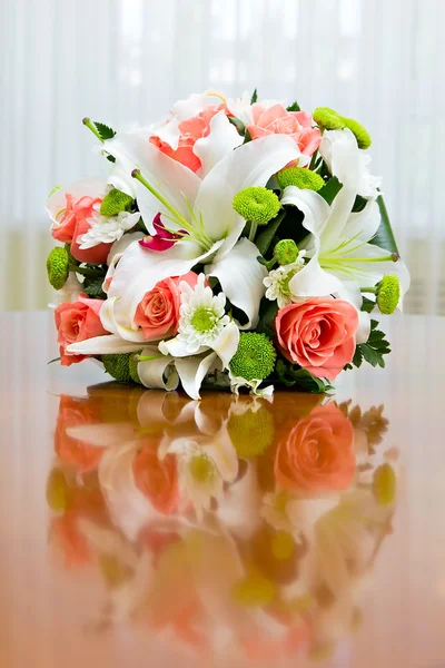 Wedding bouquet of roses and lilies for bride at a wedding party