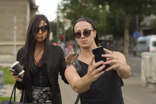 Young couple taking selfies — Stock Photo, Image