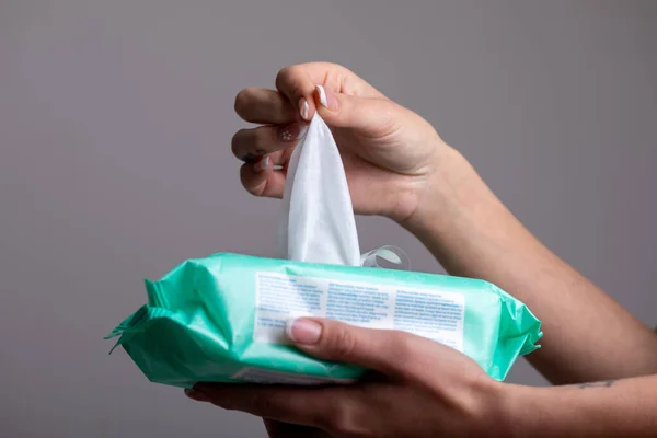 Taking baby wet wipes from the packaging - hygiene procedure and prevention of infectious diseases