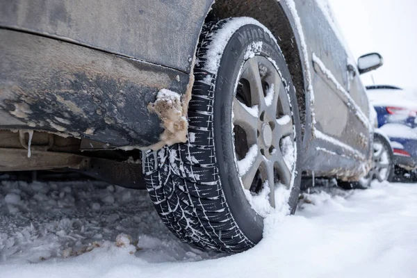 Winter tire. Car on snow road. Tires on snowy highway detail stock photo