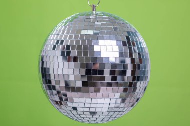 Shining Disco Ball dance music event equipment isolated on green background