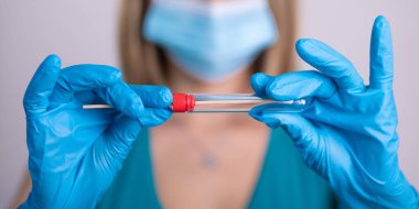 Coronavirus COVID 19 test kiti, PPE koruyucu maskesi ve eldiven taşıyan yüz maskeli hemşire, OP NP hasta numunesi almak için tüp, PCR DNA RNA test protokolü fotoğrafı