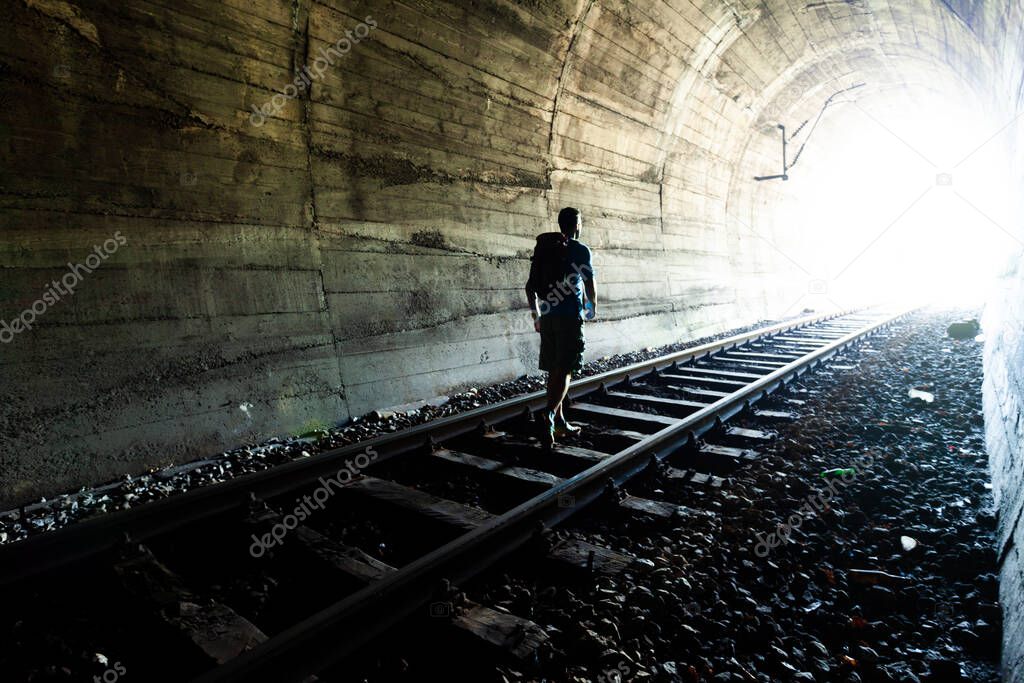 Exit from darknes - Man figure silhouete on Light at end of tunnel stock photo