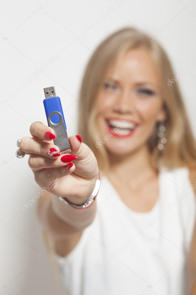 Smiling Woman With USB Memory Stick In Hands