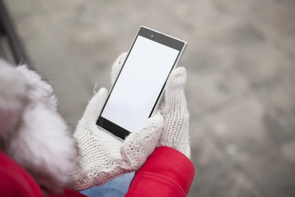 Mobile phone in hands with glowes, cold weather — Stock Photo, Image