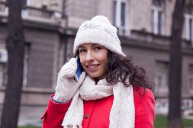 Yün şapka ve eldiven ile smartphone th gelecek elinde kadın ile