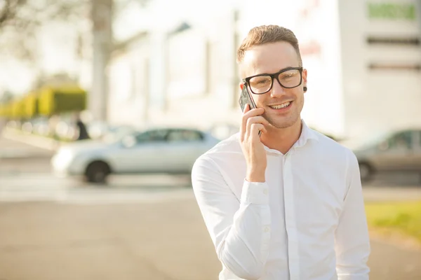 Hombre con gafas hablan por teléfono móvil en las manos — Foto de Stock