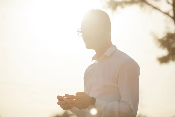 Man with glasses speak on mobile phone in hands — Stock Photo, Image