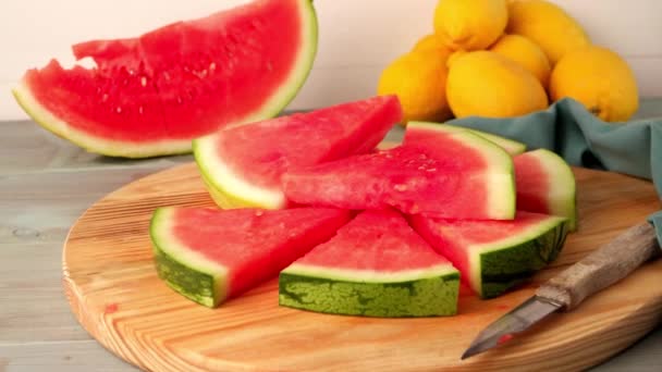 Watermelon slices on wooden table — Stock Video