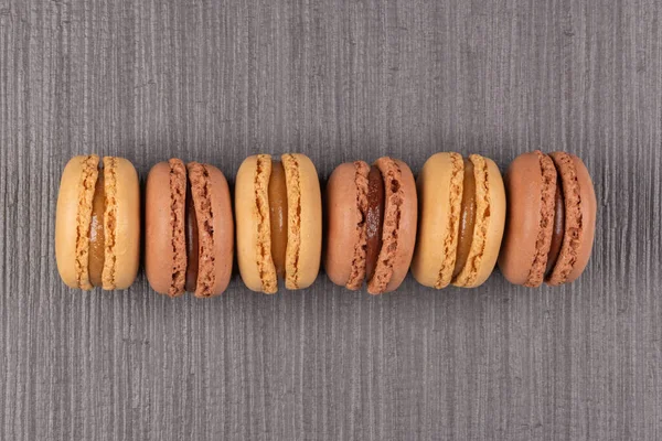 Six Coffee Chocolated Flavoured Macaroons Grey Vinyl Background — Stock Photo, Image