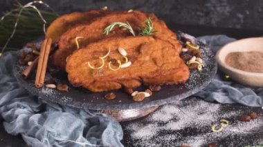 Traditional Christmas Rabanadas with lemon zest, raisins, pine nuts and cinnamon. Spanish Torrijas or french toasts close up on the countertop