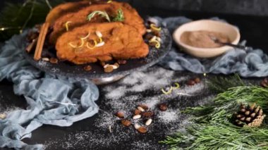 Traditional Christmas Rabanadas with lemon zest, raisins, pine nuts and cinnamon. Spanish Torrijas or french toasts close up on the countertop