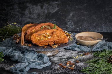 Traditional Christmas Rabanadas with lemon zest, raisins, pine nuts and cinnamon. Spanish Torrijas or french toasts close up on the countertop