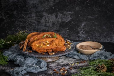 Traditional Christmas Rabanadas with lemon zest, raisins, pine nuts and cinnamon. Spanish Torrijas or french toasts close up on the countertop