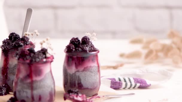 Chia Pudding Blackberries Three Portions Glass Jars White Table — Stock Video