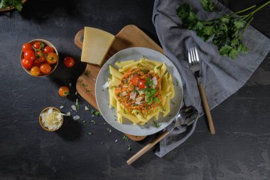 Vegetarian lentil Bolognese sauce penne pasta on a dark background. Healthy eating concept. clipart