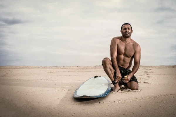 Surfista atando la lixiviación de su tabla de surf —  Fotos de Stock