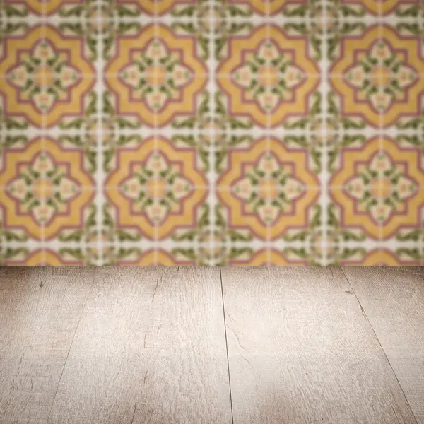 Wood table top and blur vintage ceramic tile pattern wall — Stock Photo, Image