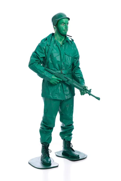 Homem em um traje de soldado de brinquedo verde — Fotografia de Stock