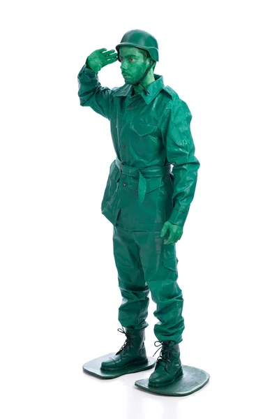 Man op een groene speelgoed soldaat kostuum — Stockfoto