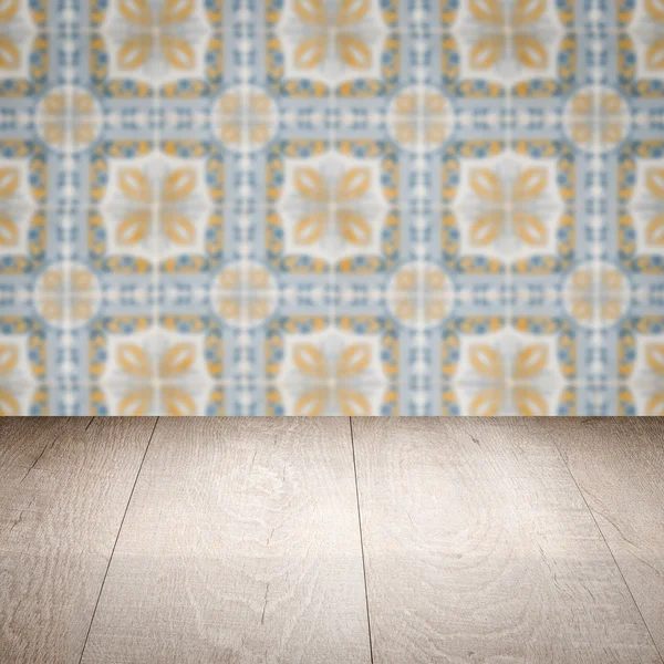 Wood table top and blur vintage ceramic tile pattern wall — Stock Photo, Image