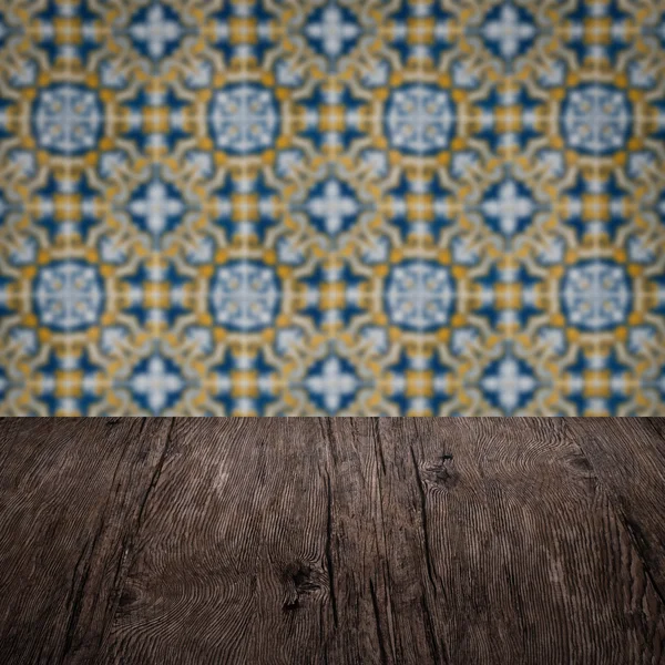 Wood table top and blur vintage ceramic tile pattern wall — Stock Photo, Image