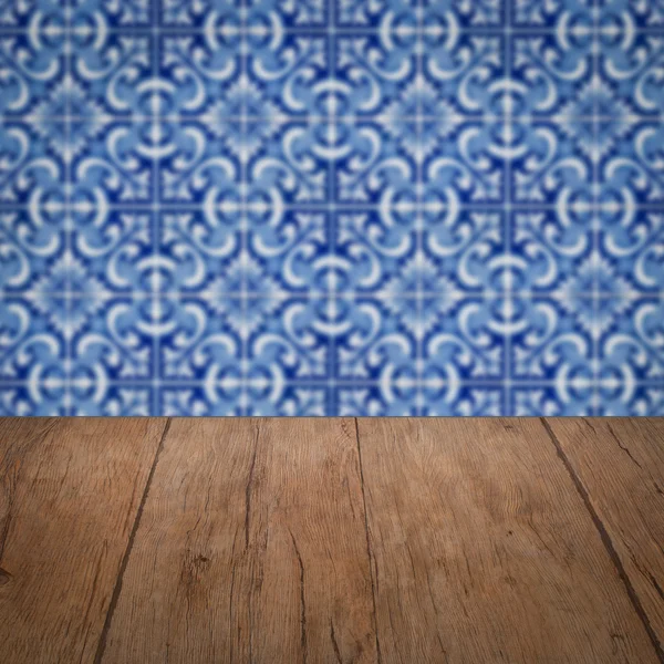 Wood table top and blur vintage ceramic tile pattern wall — Stock Photo, Image