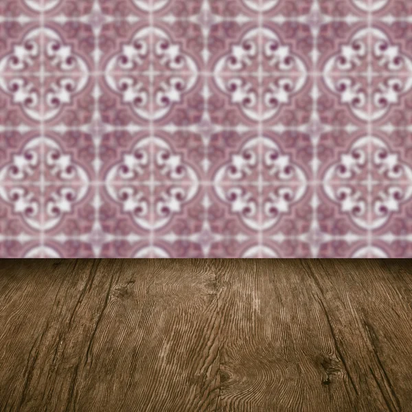 Wood table top and blur vintage ceramic tile pattern wall — Stock Photo, Image