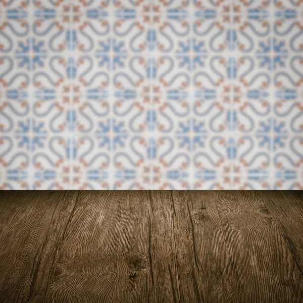 Wood table top and blur vintage ceramic tile pattern wall — Stock Photo, Image