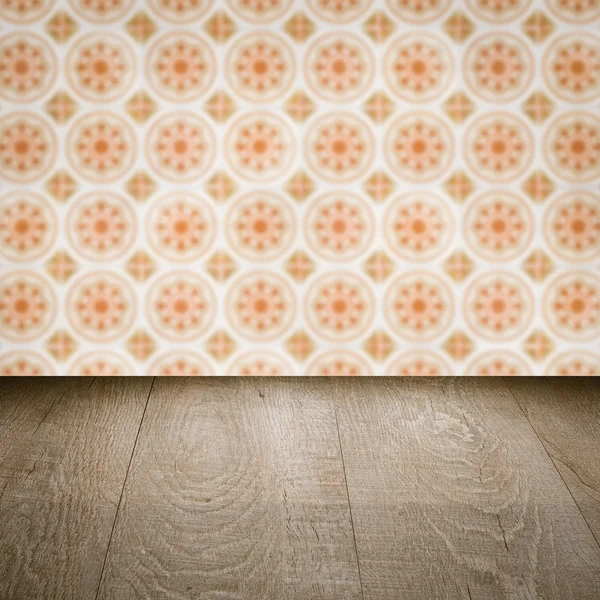 Wood table top and blur vintage ceramic tile pattern wall — Stock Photo, Image