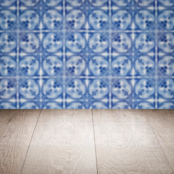 Wood table top and blur vintage ceramic tile pattern wall — Stock Photo, Image